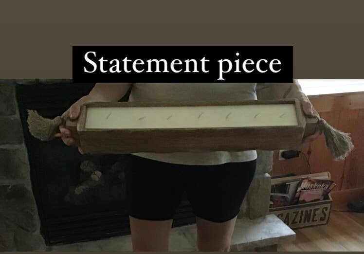 Person holding a large rectangular candle with text 'Statement piece' above it.
