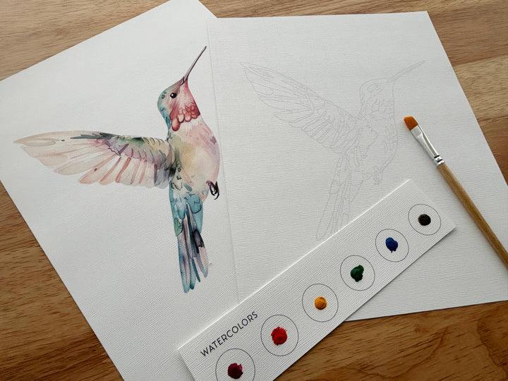 Color swatches with watercolor paint samples next to a hummingbird