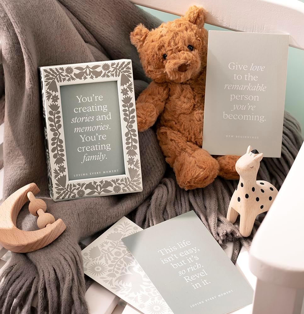 Teddy bear, framed quote, and wooden toys on a soft surface