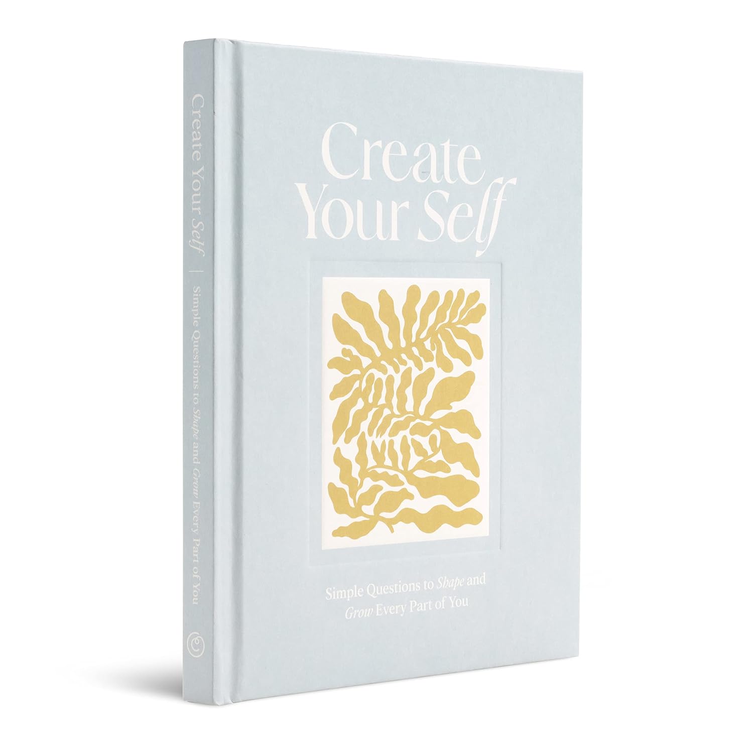Book titled 'Create Your Self' with a gold leaf design