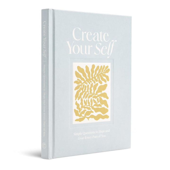 Book titled 'Create Your Self' with a gold leaf design