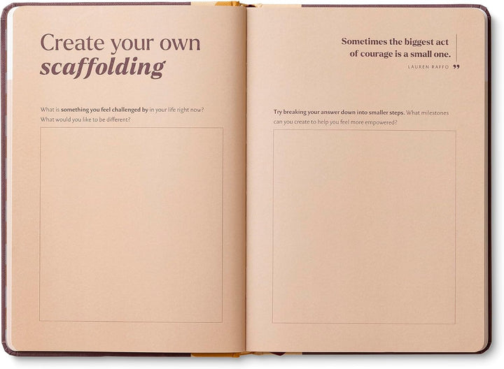 Open notebook with text prompts on beige pages