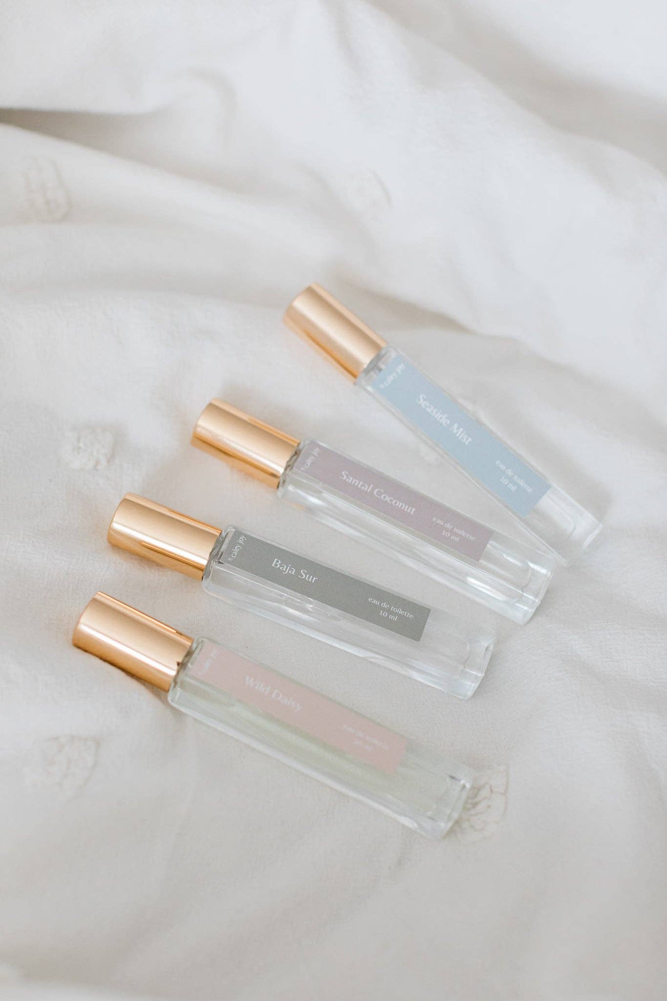 Three small perfume bottles with gold caps