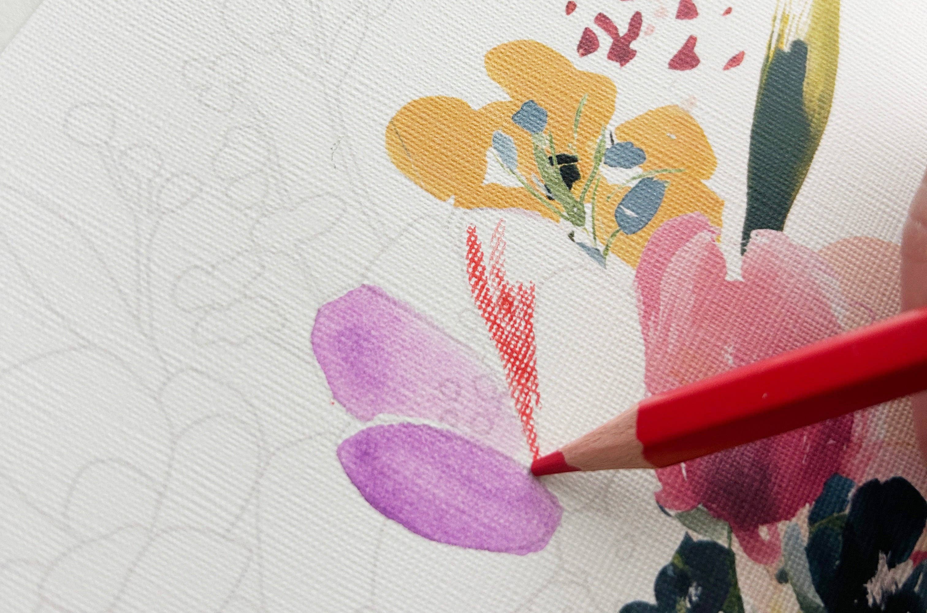 Color swatch with a red pencil next to a floral design on textured paper