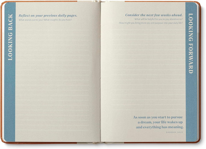 Open notebook with prompts for reflection and planning on each page.