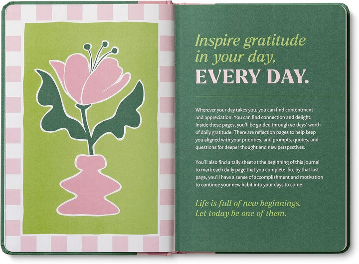 Open book with a pink flower illustration on a green background and motivational text.