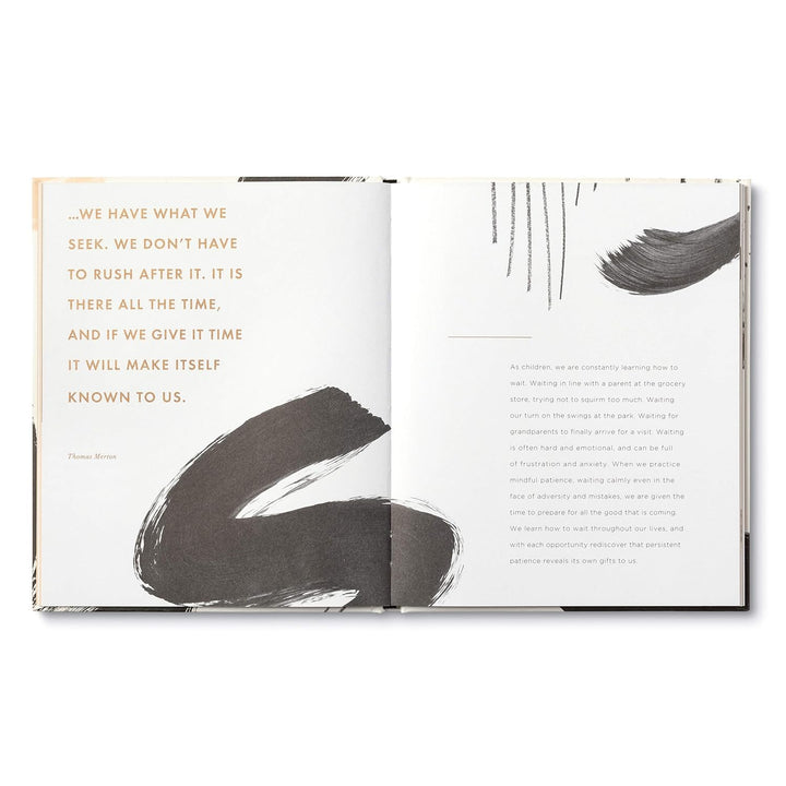 Open book with text and abstract black brush strokes