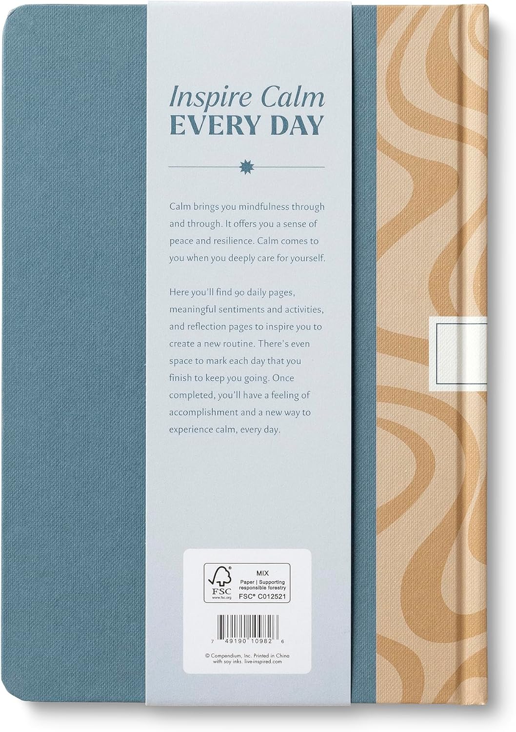 Notebook with blue cover and beige patterned side, featuring text 'Inspire Calm Every Day'.
