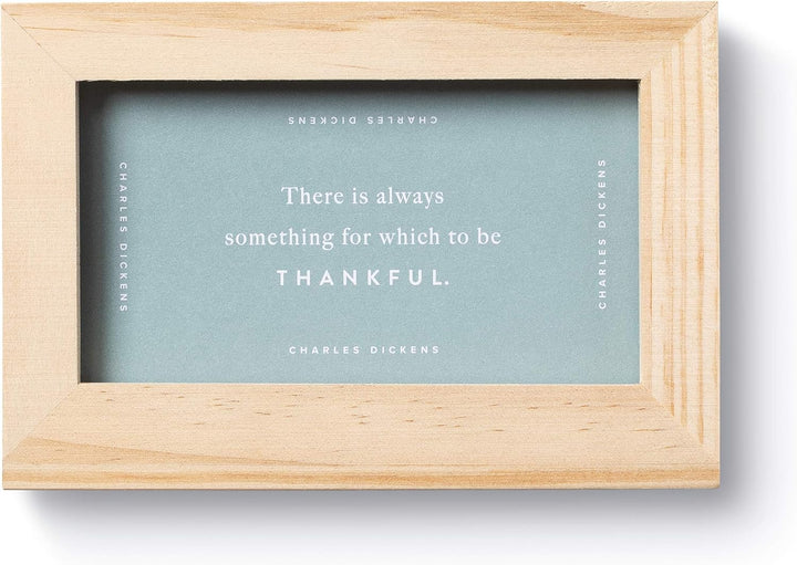 Wooden frame with a quote by Charles Dickens