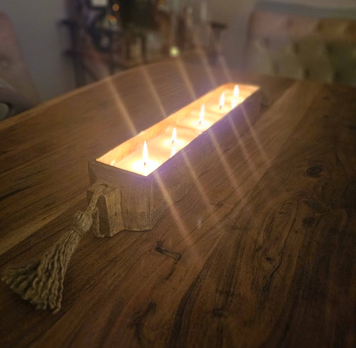 Rectangular candle holder with multiple candles on a wooden table