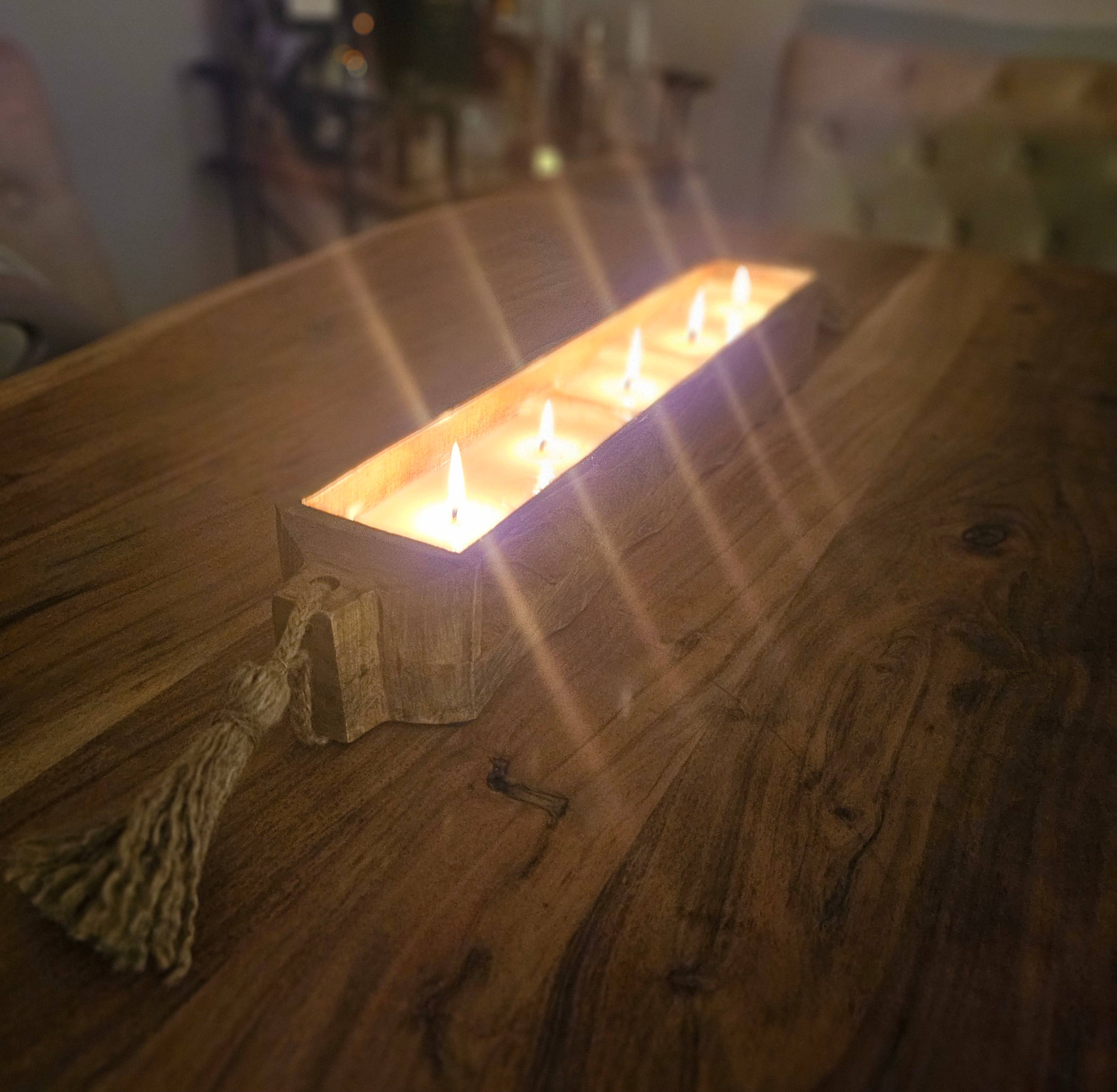 Rectangular candle holder with multiple candles on a wooden table