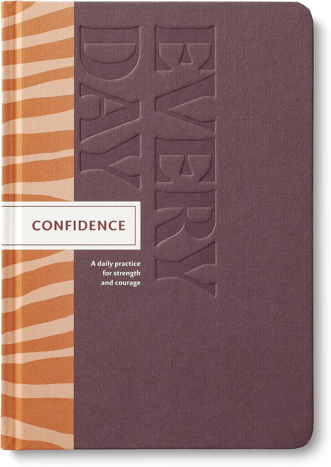 Journal with 'Every Day Confidence' text on a purple cover 