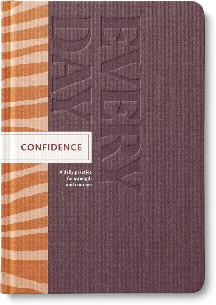 Journal with 'Every Day Confidence' text on a purple cover 