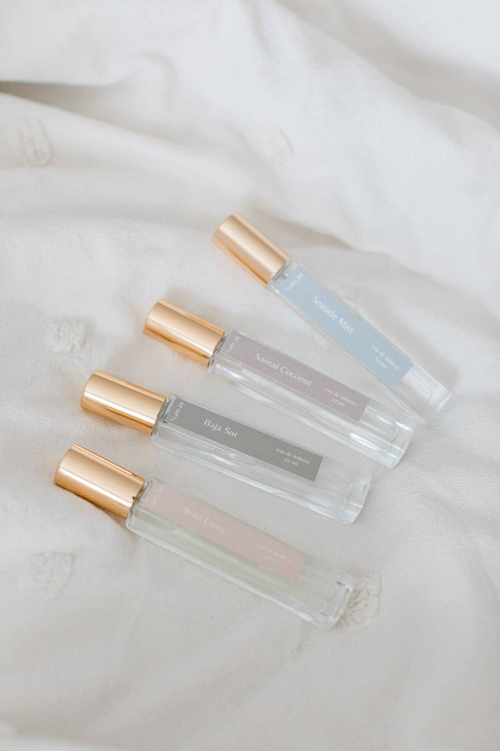 Three small perfume bottles with gold caps