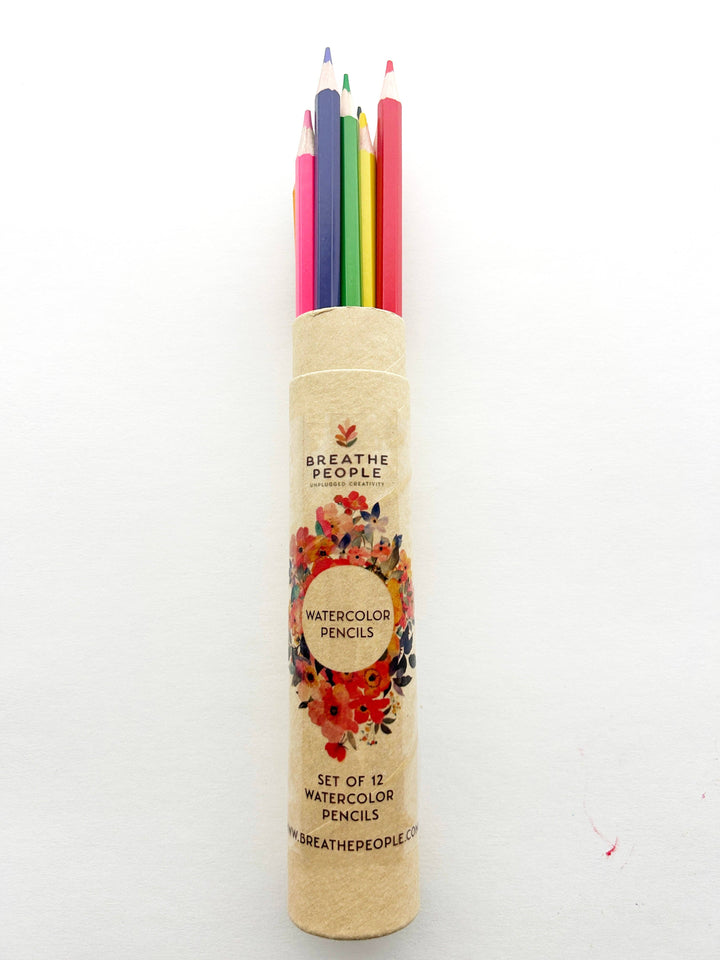 Set of watercolor pencils in a cylindrical holder with 'Breathe People'