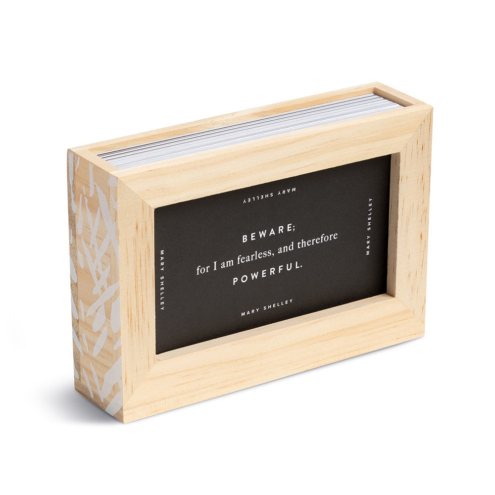 Wooden box with a black interior featuring a quote