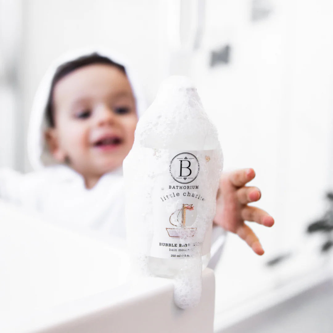 Child holding a Bathorium bottle
