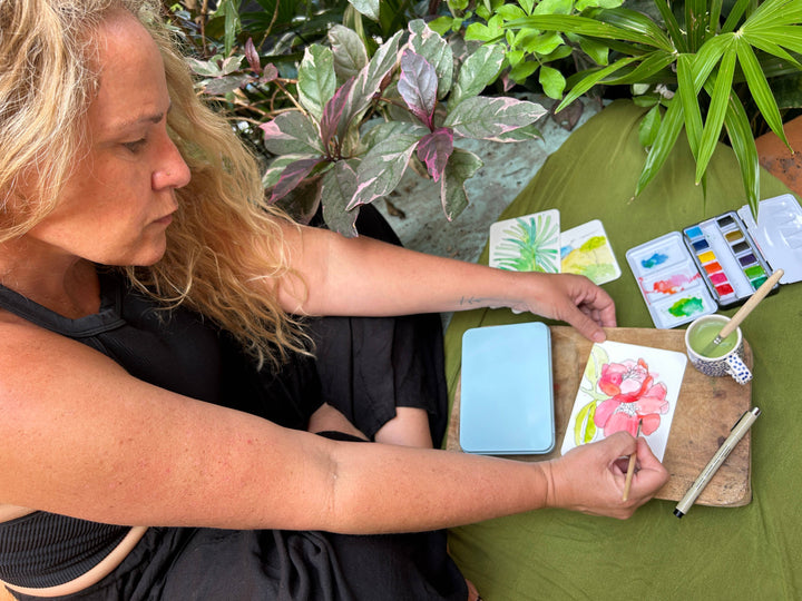 Woman painting with watercolors outdoors