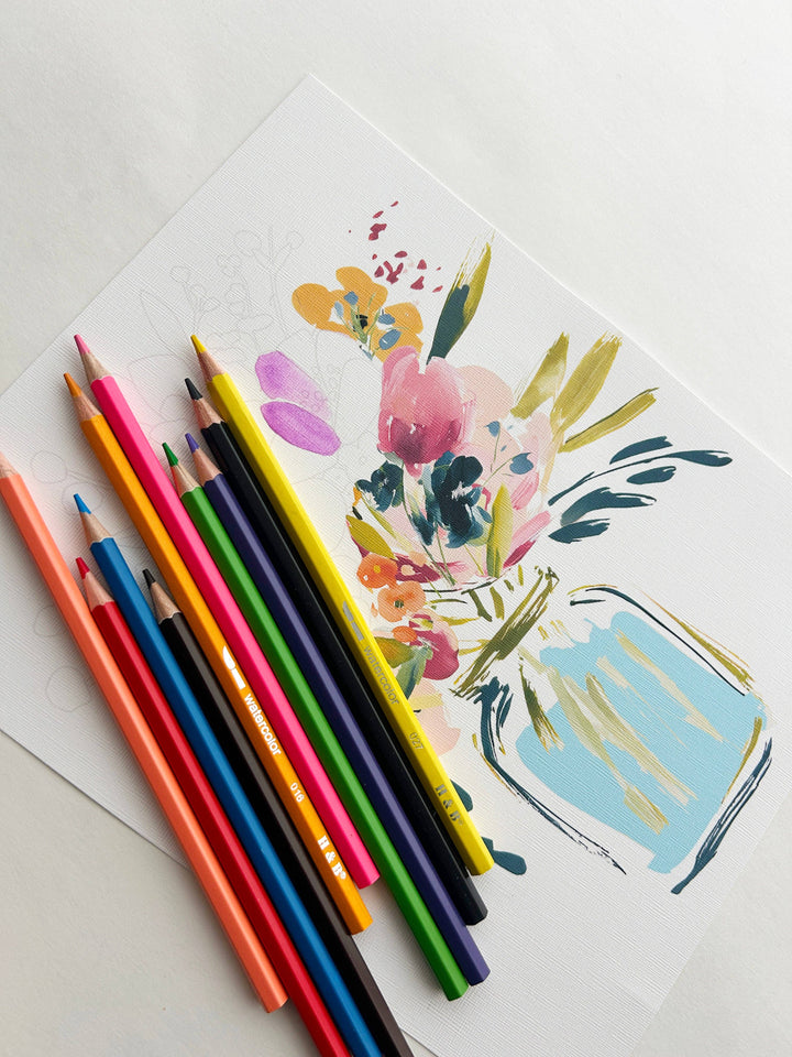 Colorful pencils on a white surface with a floral illustration of a jar.