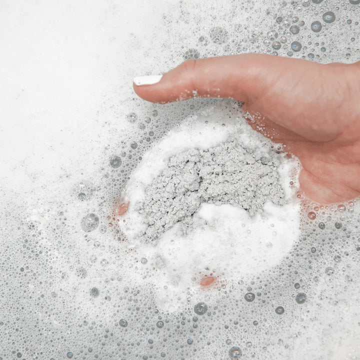 Hand interacting with soapy water