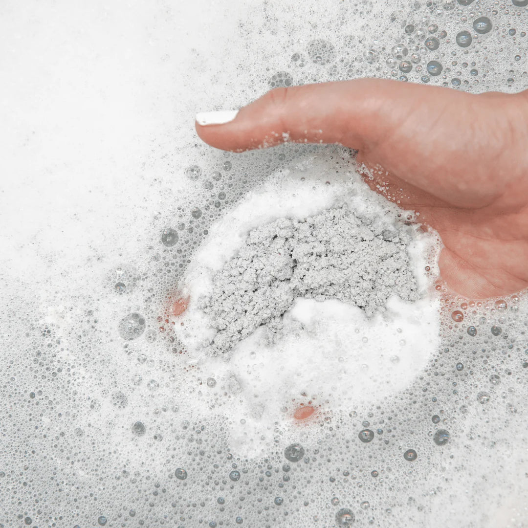 Hand interacting with soapy water