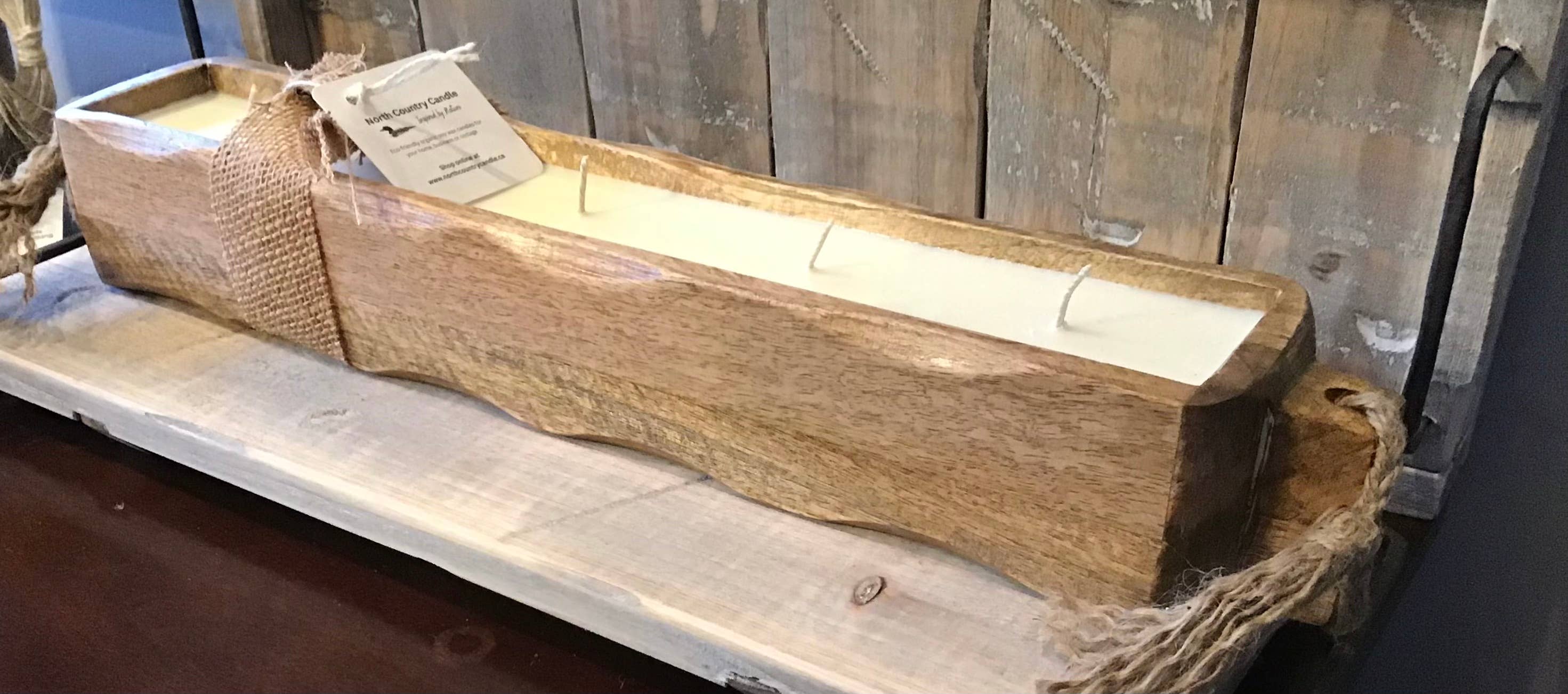 Wooden candle holder with a lid on a wooden surface