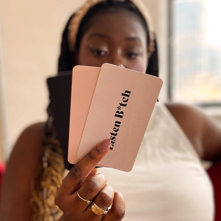 Person holding a pink card with text