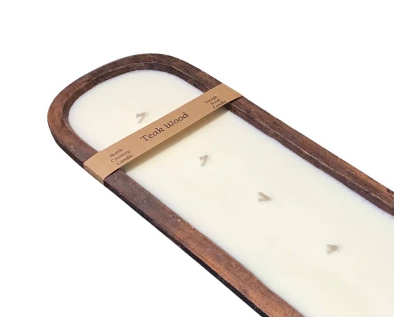 Long white candle in a wooden holder with 'Teak Wood' label