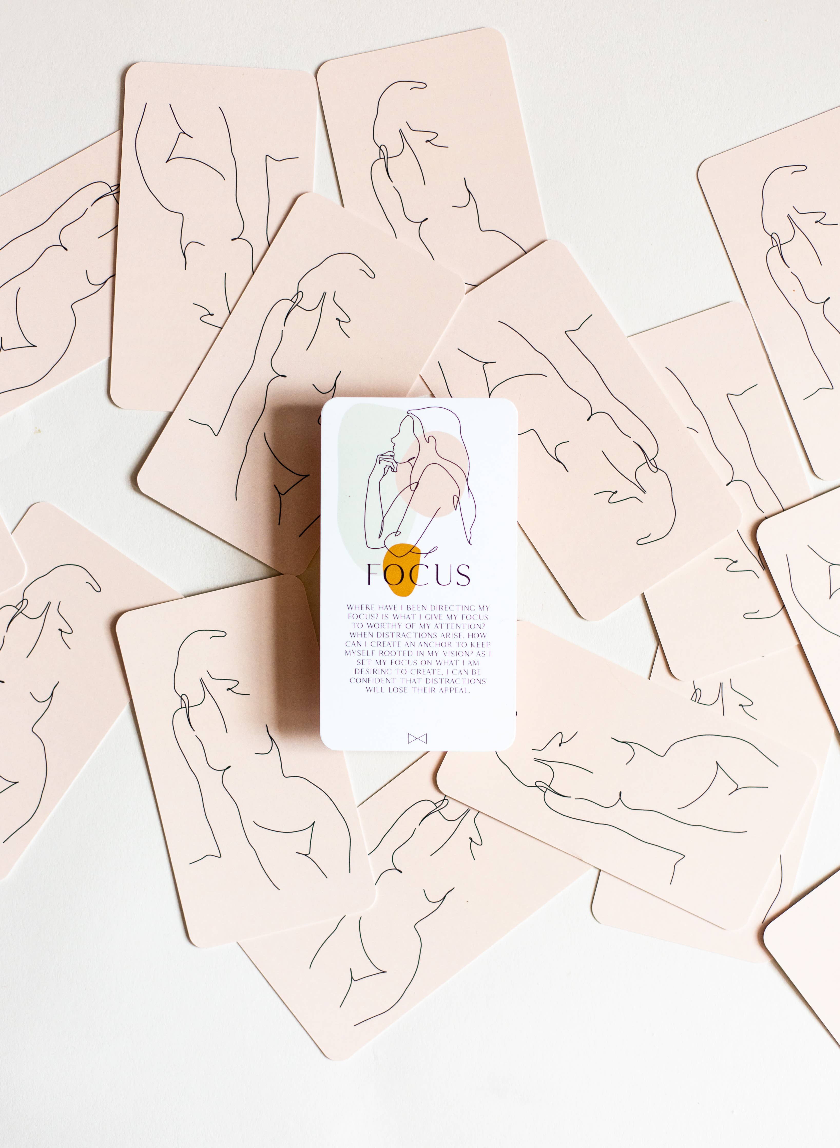 Card game box labeled 'Focus' surrounded by cards with line art