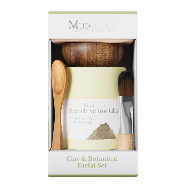 Mud & Botanical Facial Set in packaging with a jar, brush, and wooden spoon.