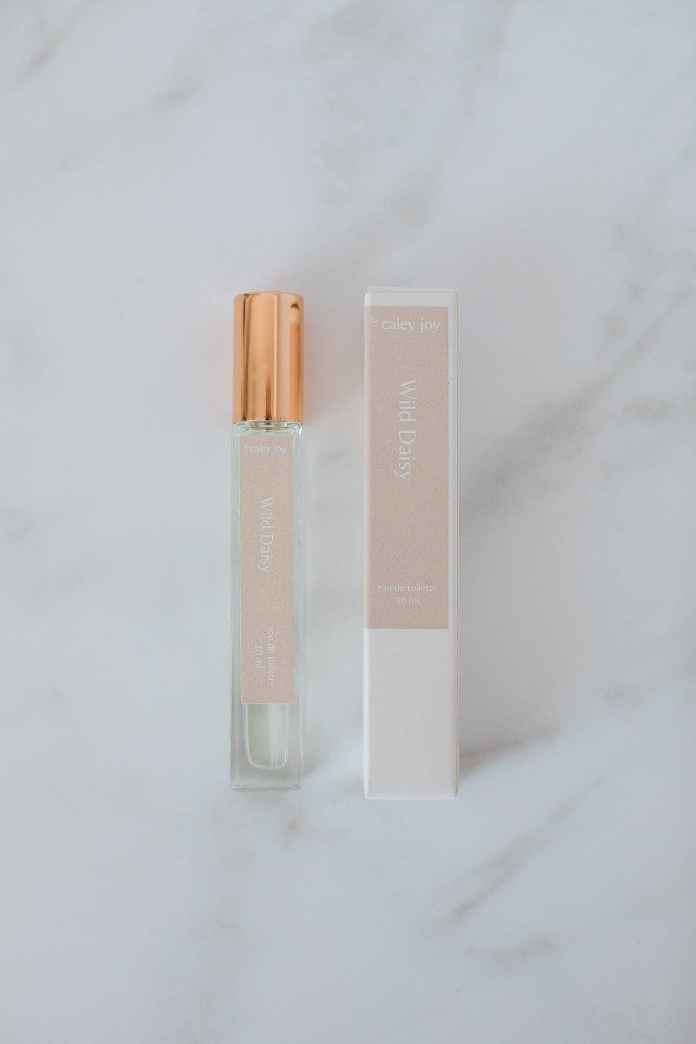 Perfume bottle with gold cap and packaging