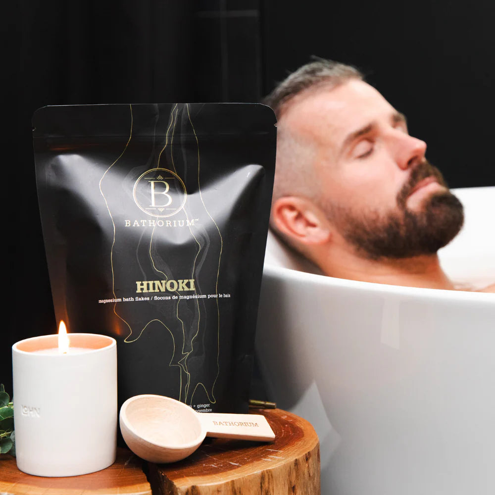 Man relaxing in a bathtub with Hinoki bath bombs, 
