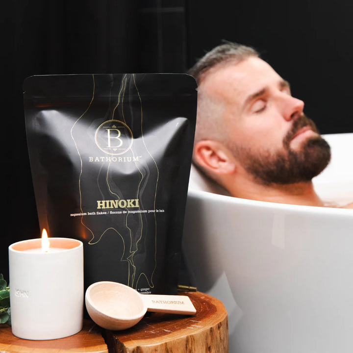 Man relaxing in a bathtub with Hinoki bath bombs, 