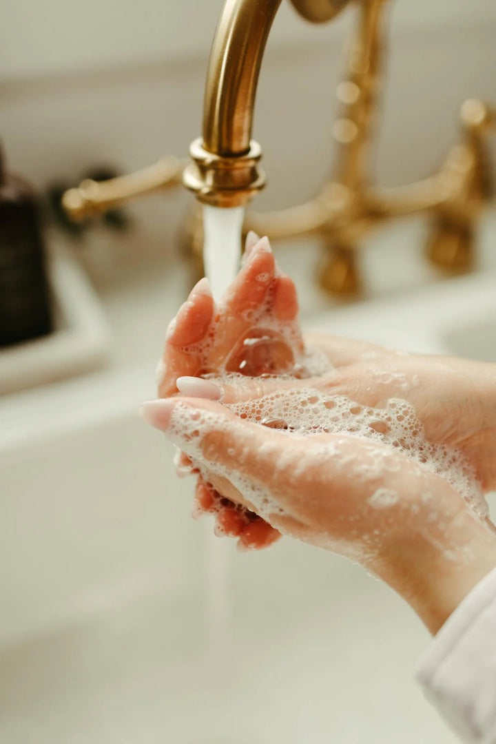 Person washing hands with soap